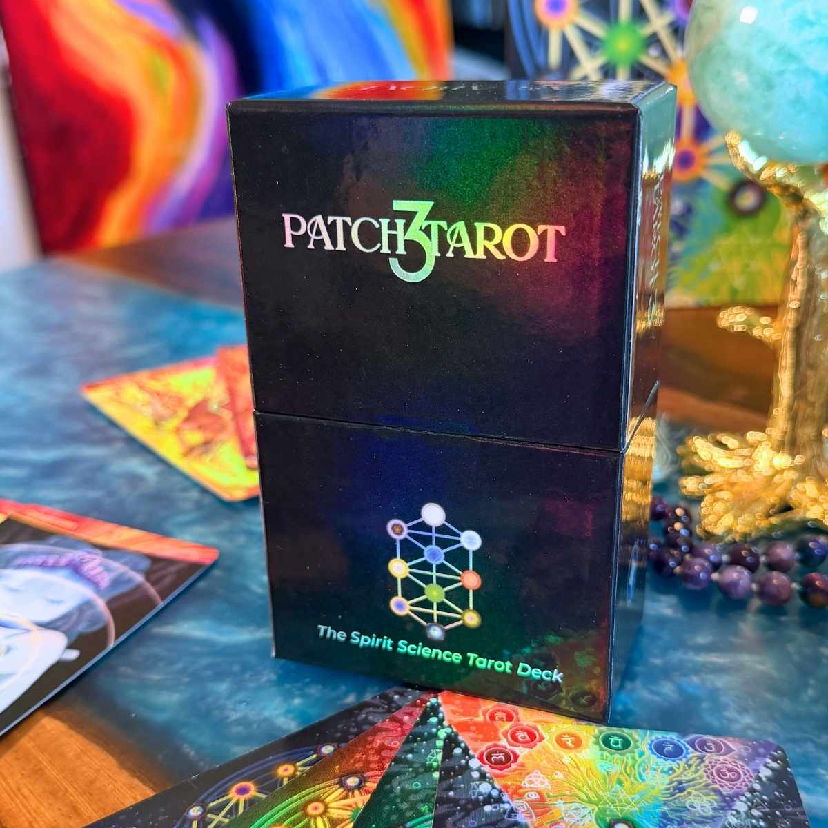 Patch 3 Tarot cards packaging on a table with tarot cards and crystals.