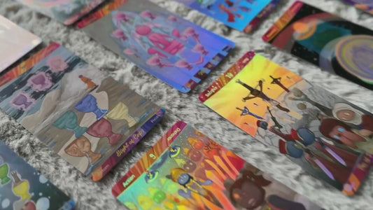 Video showing colorful Patch Tarot 3 cards spread across a marble surface, highlighting the deck's hand-drawn holographic artwork.